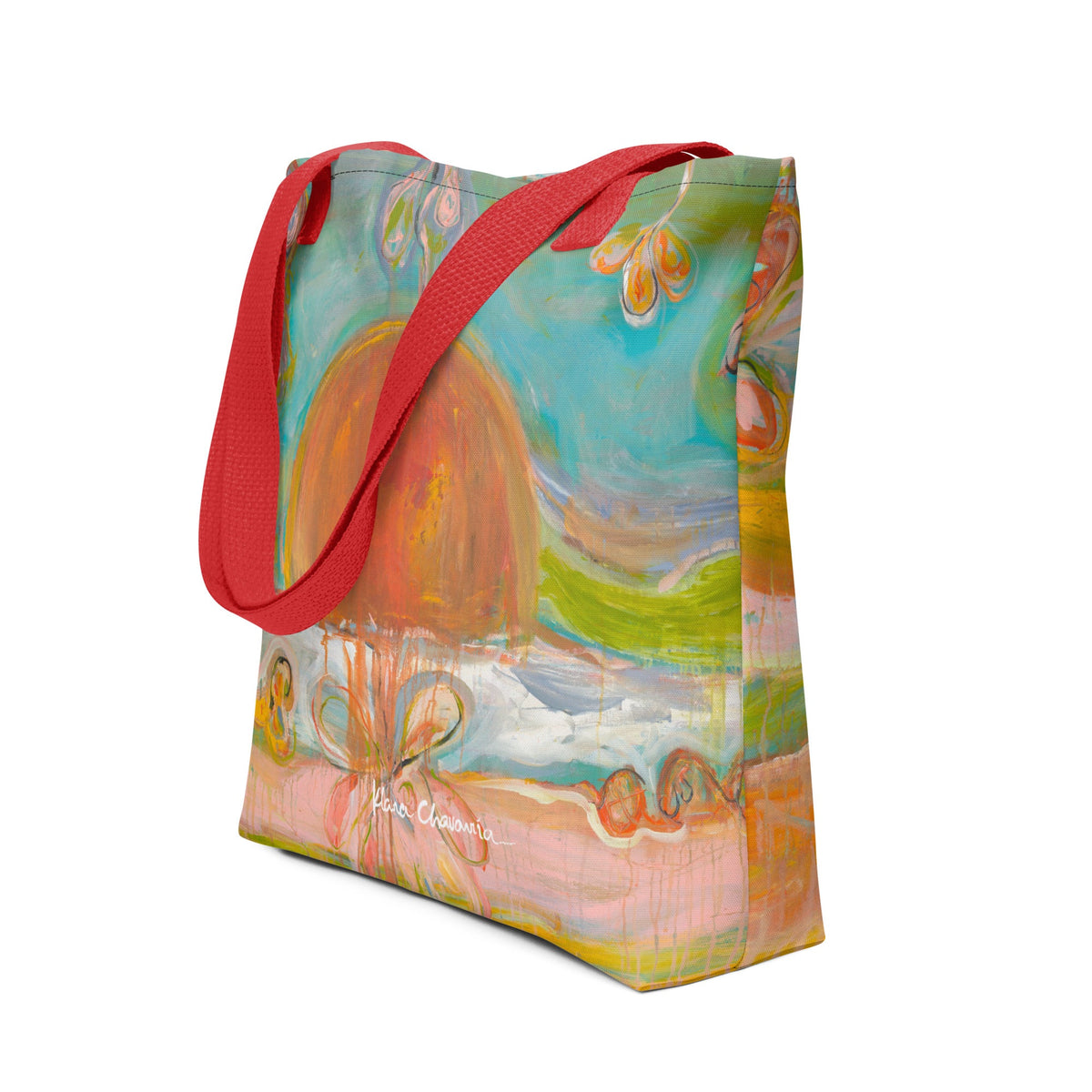 Angled view of the tote with an orange sun over teal sky and pink ground, red handles