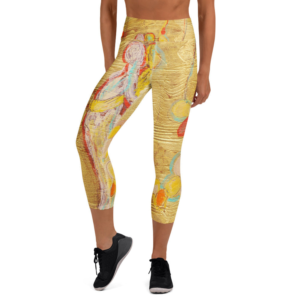 Front view of gold capri leggings with a pale figure and orange flowers, LOVE AS NATURE I by Klara Chavarría