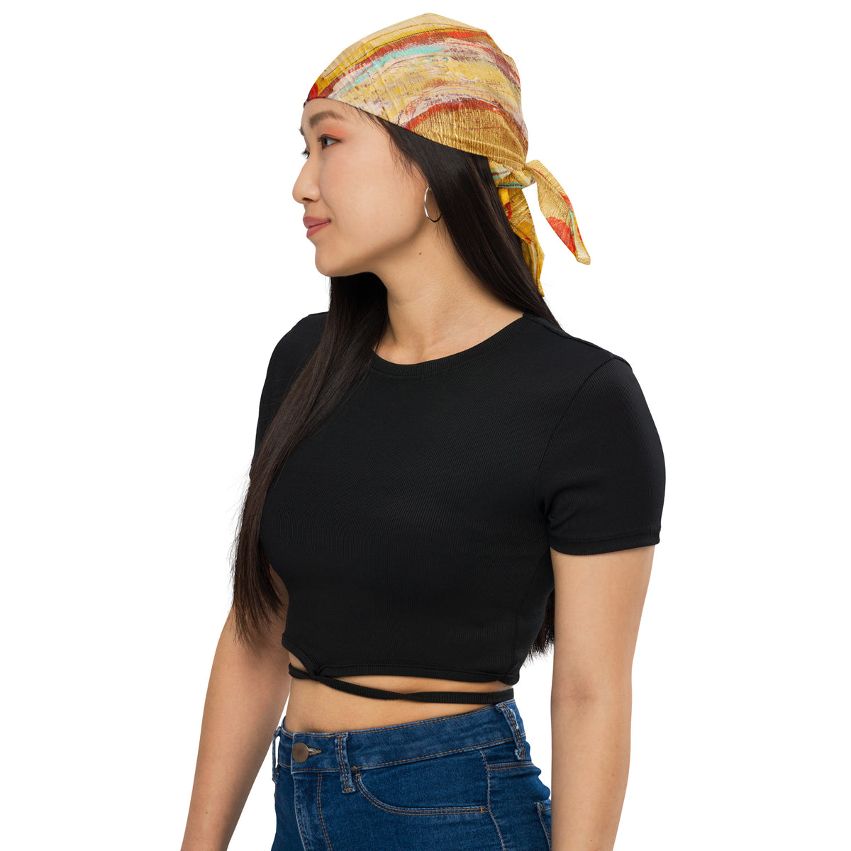 Side profile of model in a black crop top wearing the gold bandana tied over the head