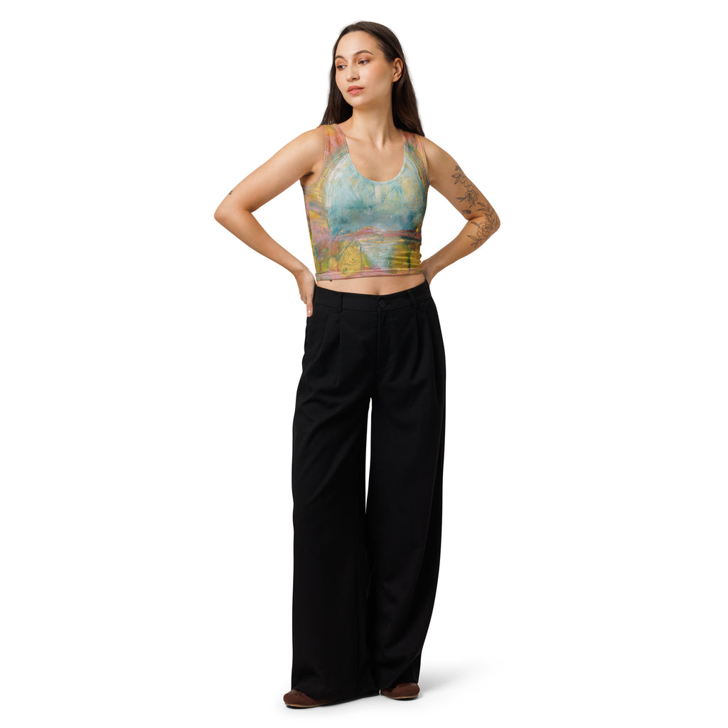 Model in the pastel crop top and black wide-leg pants, hands on hips, looking aside