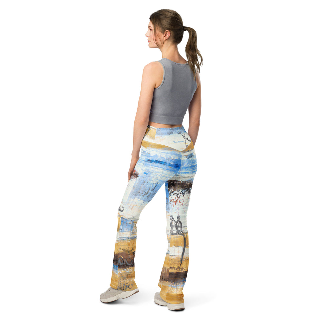 Back view of model with a ponytail in the flare leggings and light gray sneakers