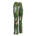 Front three-quarter view of the flare leggings on their own, pale figures with outstretched arms on green