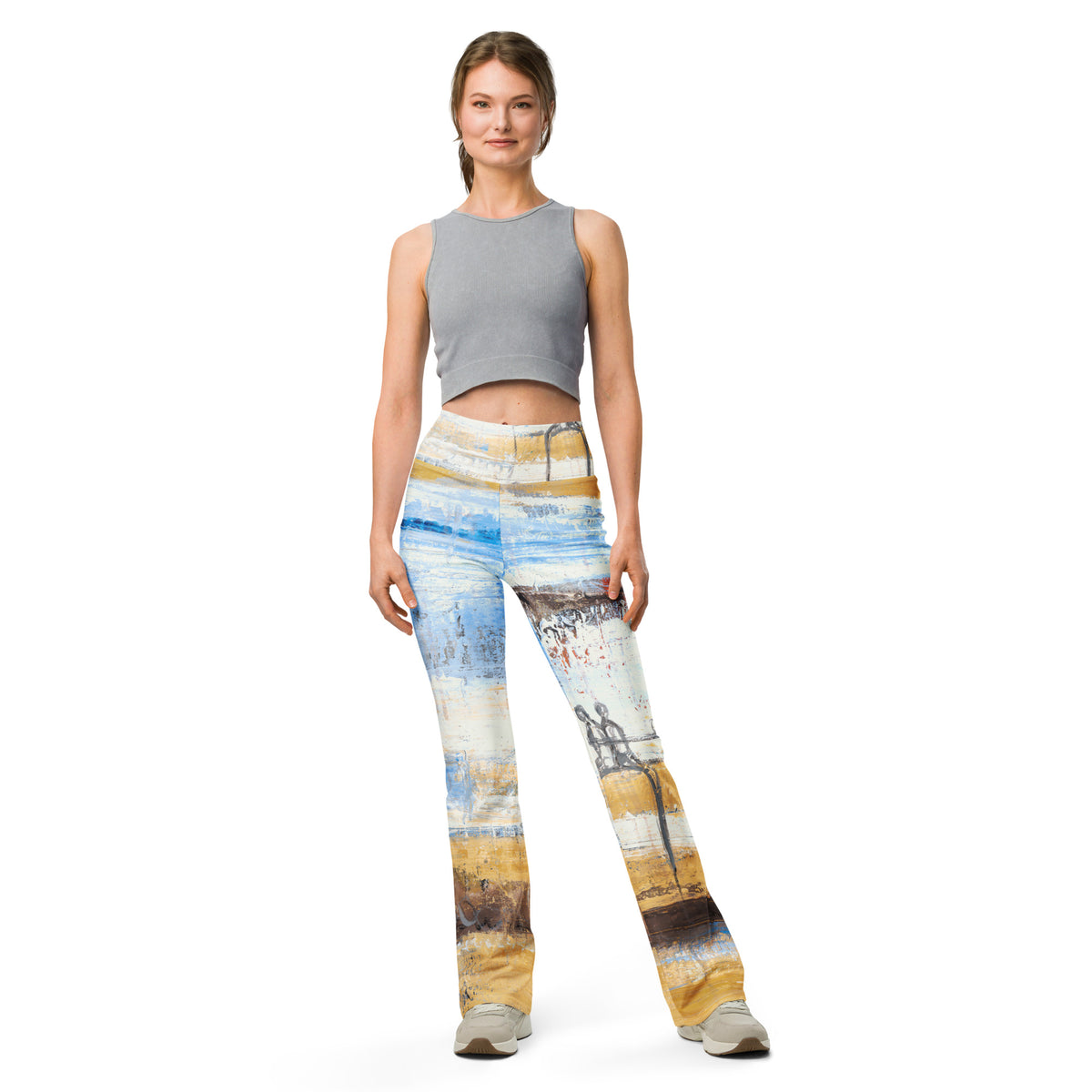 Front view of model in a gray crop tank and blue and ochre flare leggings, BALANCING LOVE by Klara Chavarría