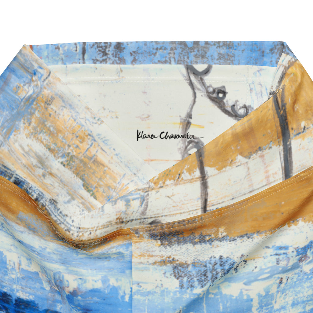 Folded waistband opened to show the black signature inside, ochre and blue strokes around it