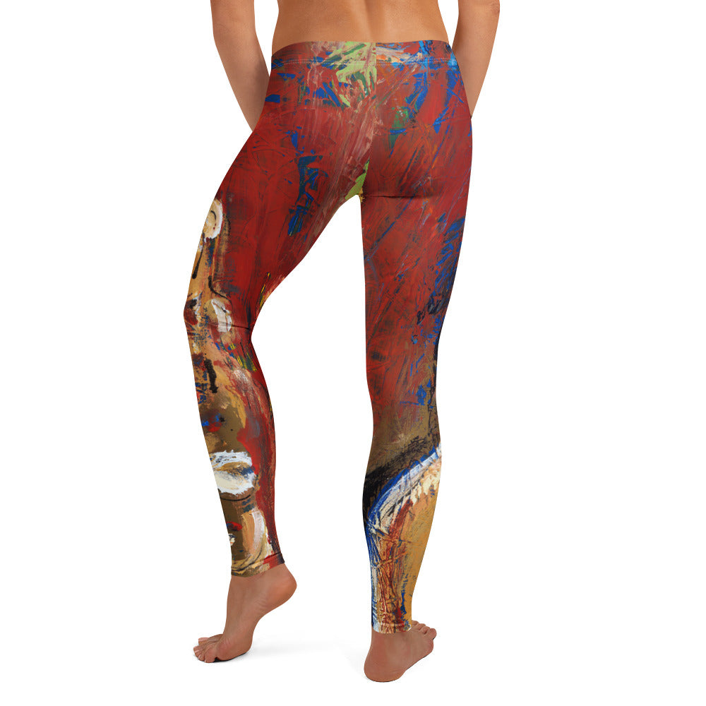 Back view of barefoot model in red leggings with blue streaks and tan figures near the ankles