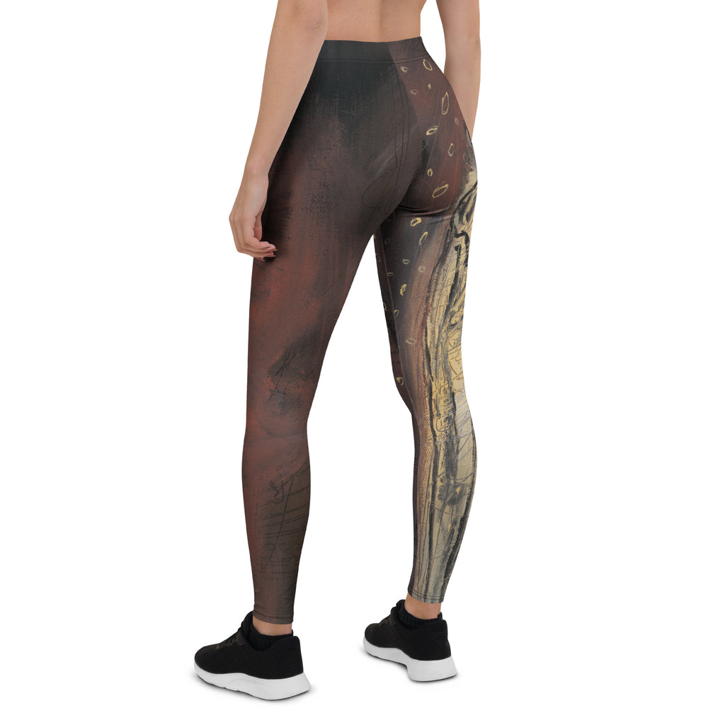 Back view of the leggings with a tall gold and black sketched figure down one leg