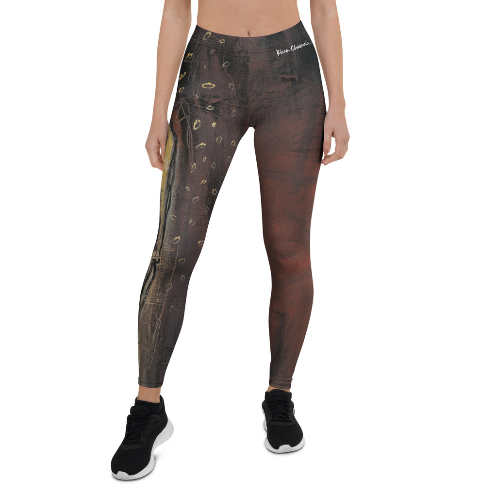 Front of dark brown and rust leggings with gold rings and white waistband signature, ILLUMINATION by Klara Chavarría