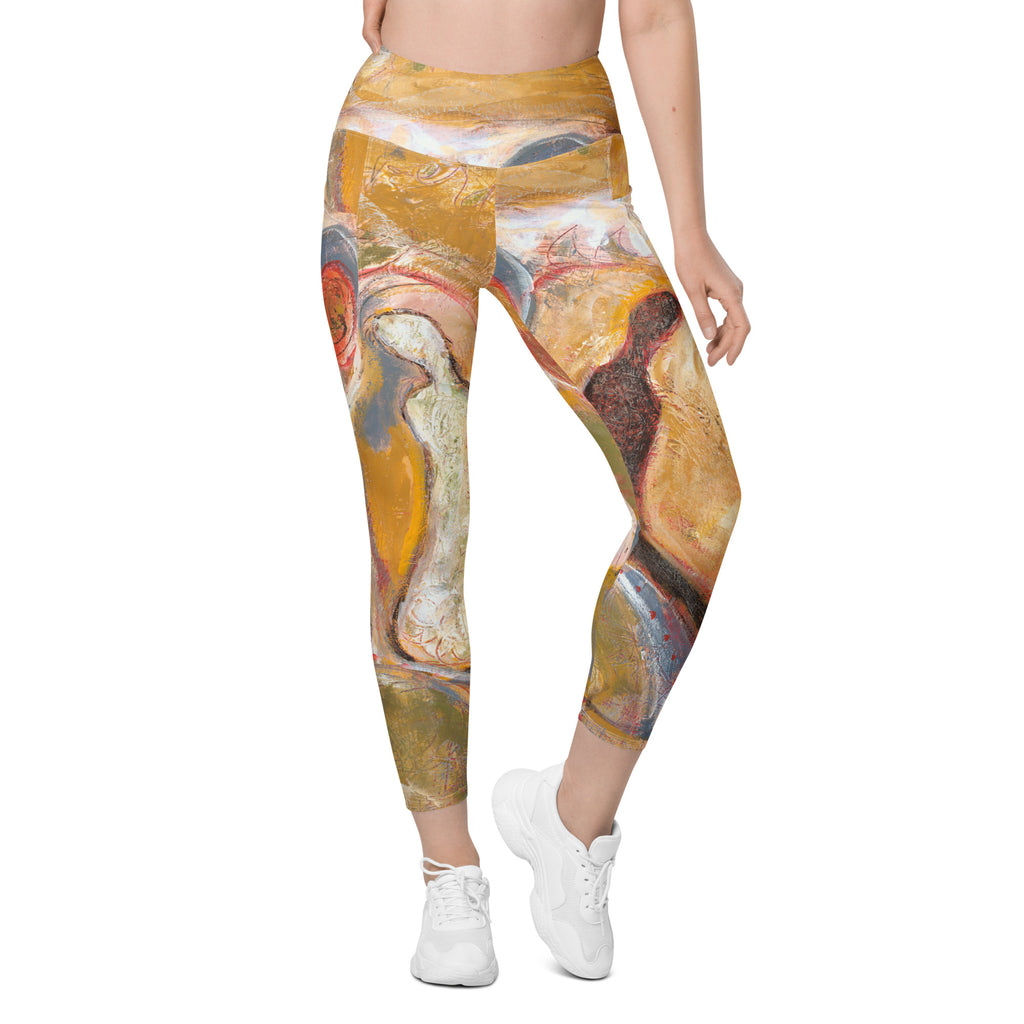 Front of gold leggings with pockets, cream and dark brown figures, PATH TO FORGIVENESS by Klara Chavarría
