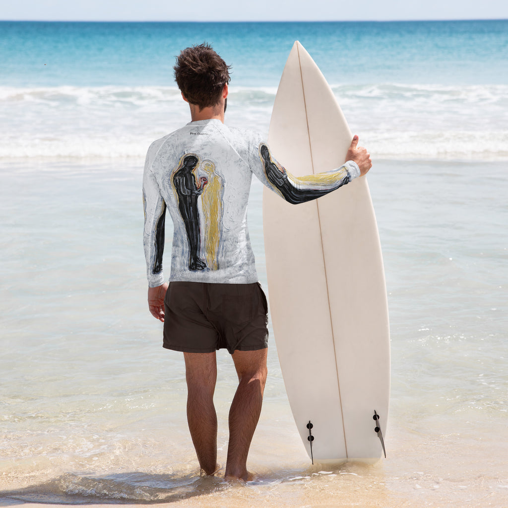 Back view of man at the shoreline holding a white surfboard, rash guard showing the two figures and signature