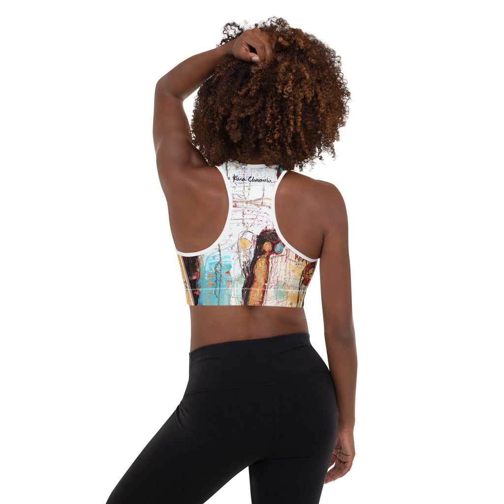 Back view of model touching her hair, racerback with signature and ochre figure