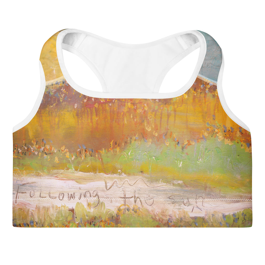 Flat front of the sports bra with the words Following the sun on a pale band, FOLLOWING THE SUN by Klara Chavarría