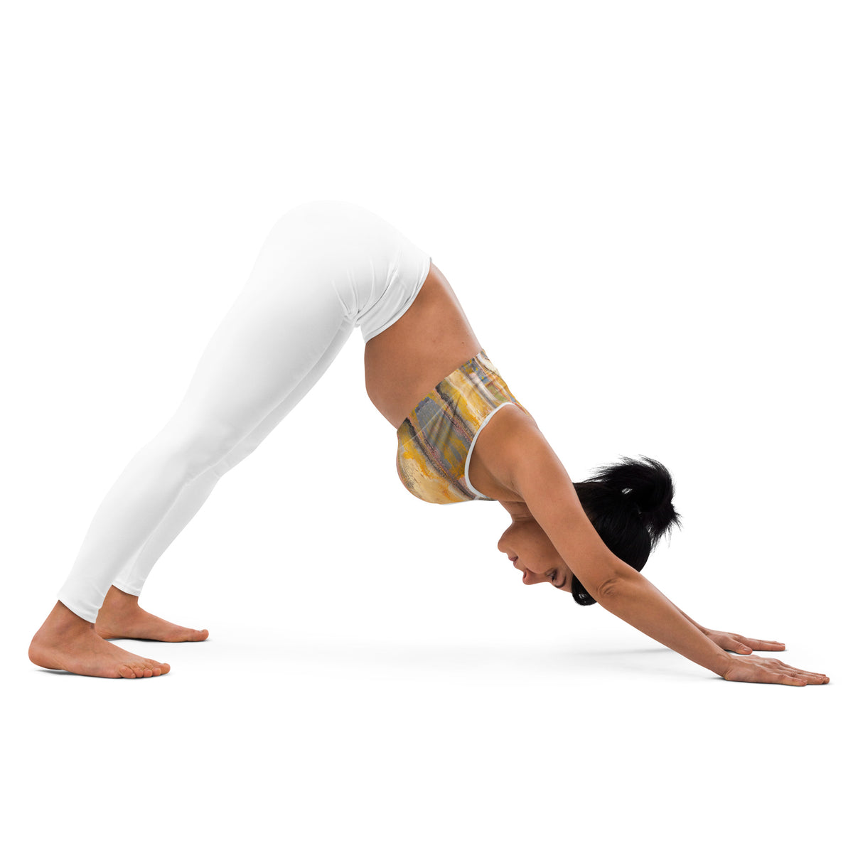 Model in downward dog pose, gold and gray bra seen from the side