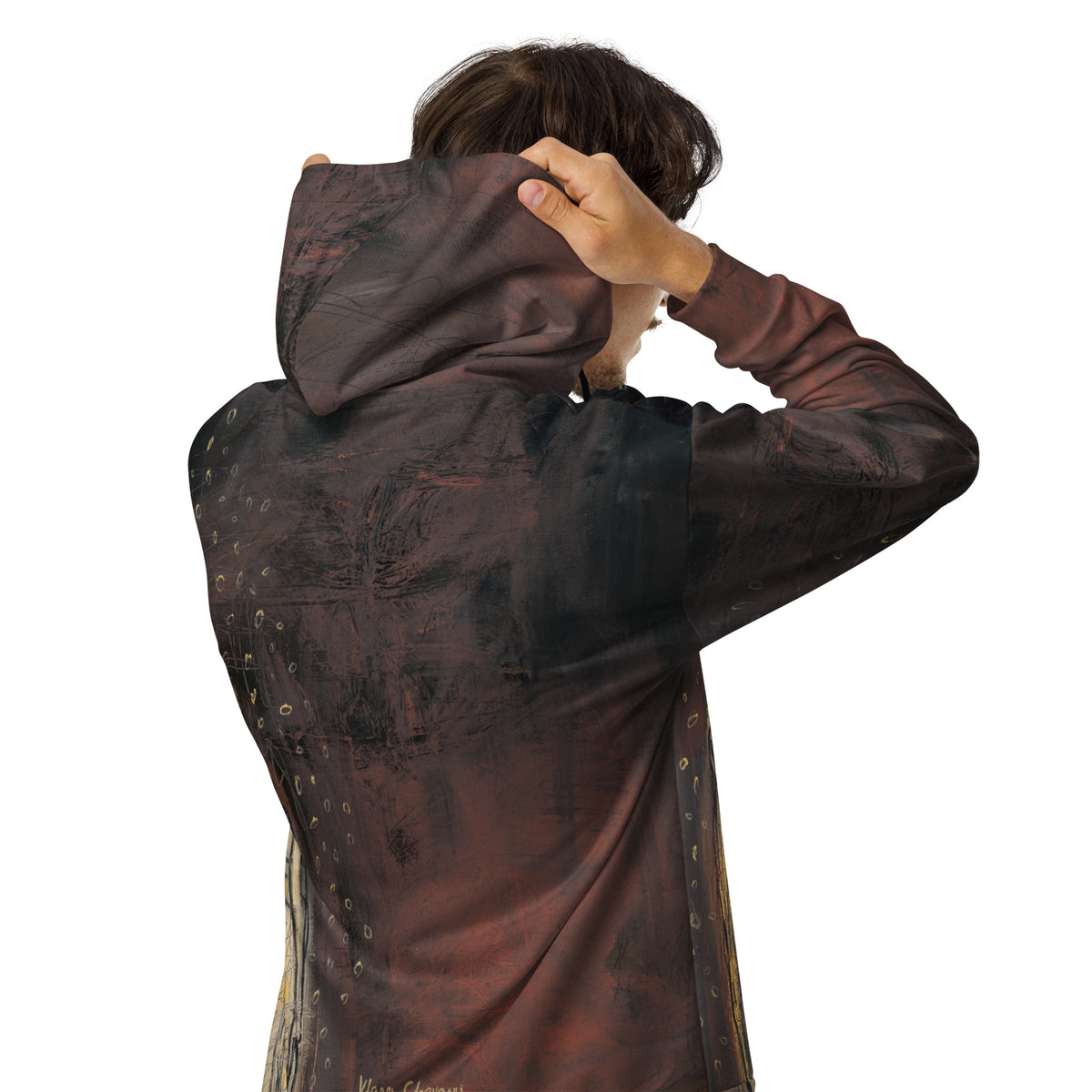 Back view of a person pulling up the hood of the rust hoodie, gold rings along one side