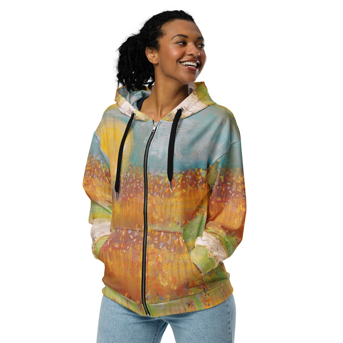 Smiling model in the zipped FOLLOWING THE SUN hoodie with hands in the pockets, turquoise and golden painted print
