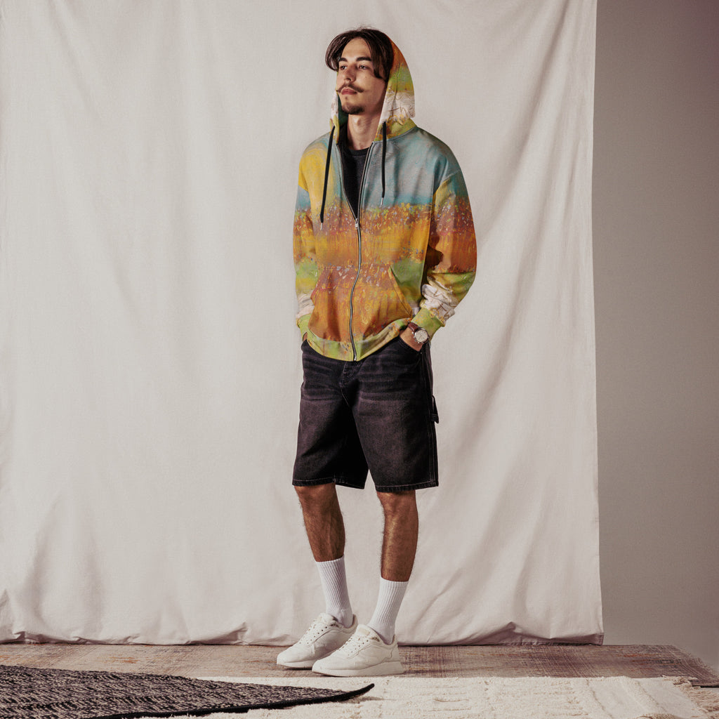 Model wearing the FOLLOWING THE SUN zip hoodie with the hood up, black denim shorts and white socks in a studio