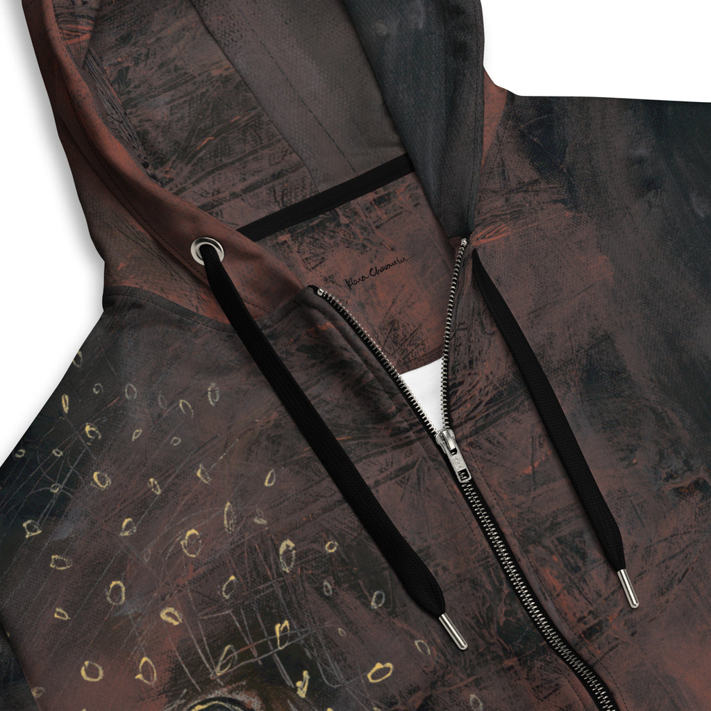 Close-up of the hood with black drawstrings, silver zipper, gold rings and a small signature
