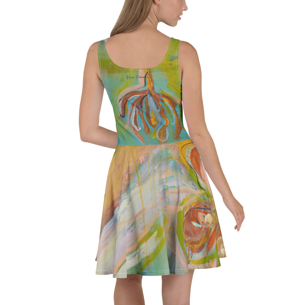 Back view of model in the dress with turquoise bodice, teal signature and hanging rust and gold flower shapes