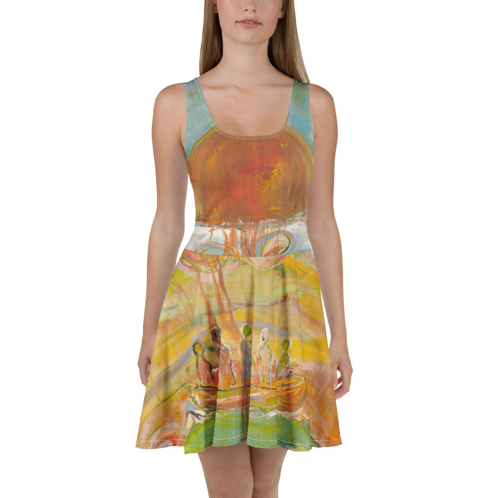 Front view of model in sleeveless skater dress with an orange sun on the bodice and gold and green swirls, GARDEN OF ILLUSIONS by Klara Chavarría