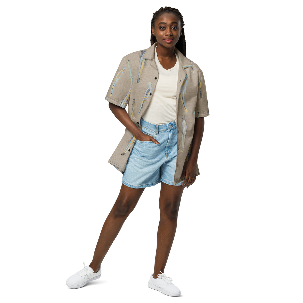 Model wearing the shirt open over a cream top and light denim shorts, hand in pocket