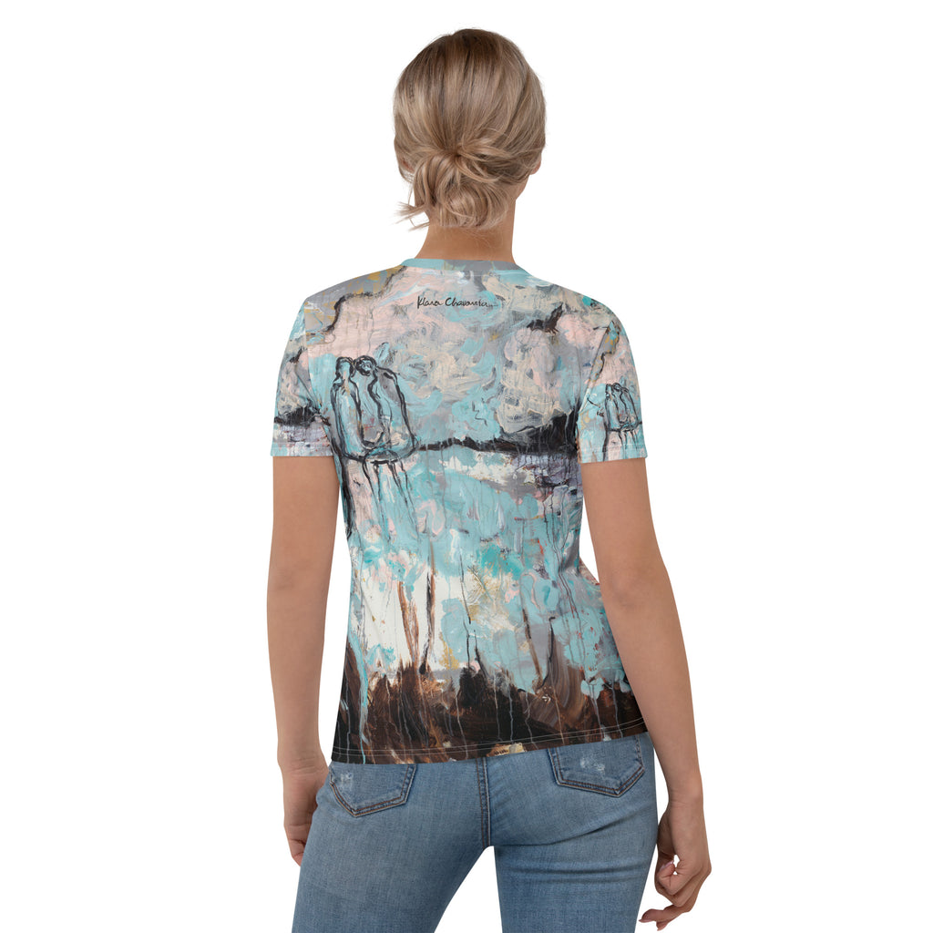 Back view of model with hair in a bun wearing the tee, signature and two figures across the shoulders