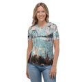 Smiling model in the aqua, pink and brown print tee and light jeans, front view