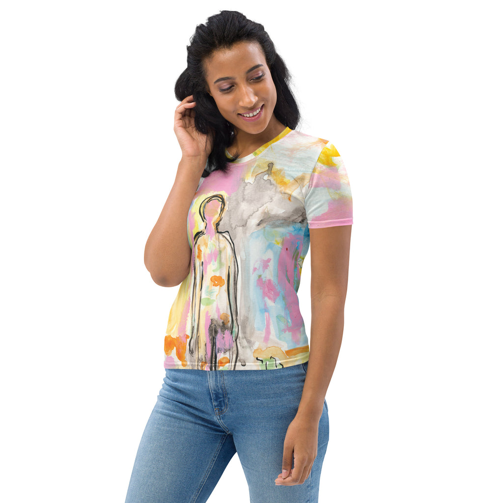Smiling model with dark hair looking down in the pastel tee and blue jeans, hand by her face