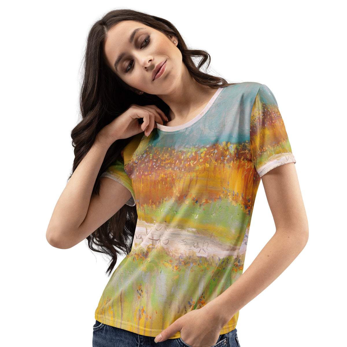 Model with long dark hair touching her neck, tee with orange meadow and teal sky