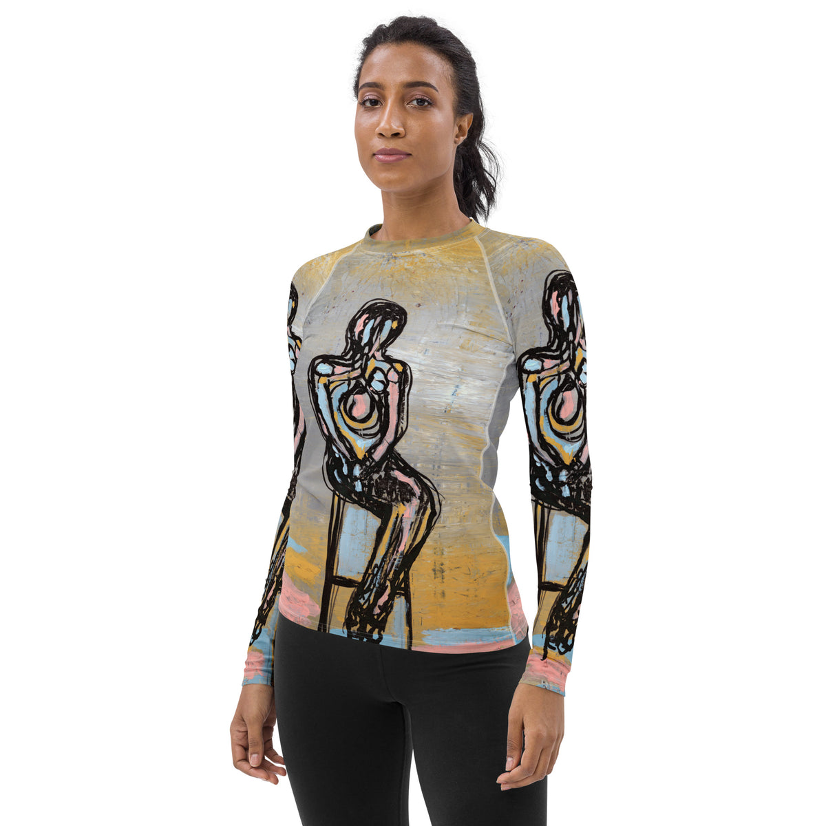 Model with dark hair facing forward in the rash guard, seated figures on chest and sleeves