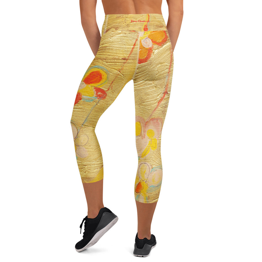 Back view of capris with orange flowers and a red signature on the waistband