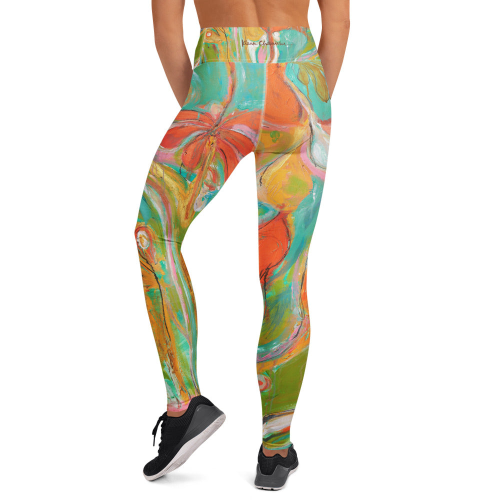 Back view of the leggings with orange flower and a signature on the waistband