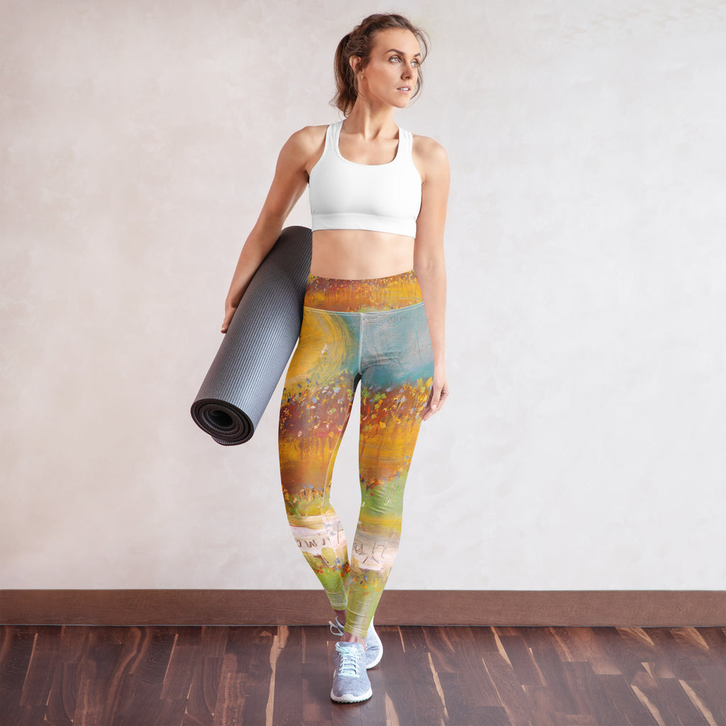 Model with a gray mat in leggings of a yellow sun, teal sky and flower field, FOLLOWING THE SUN by Klara Chavarría