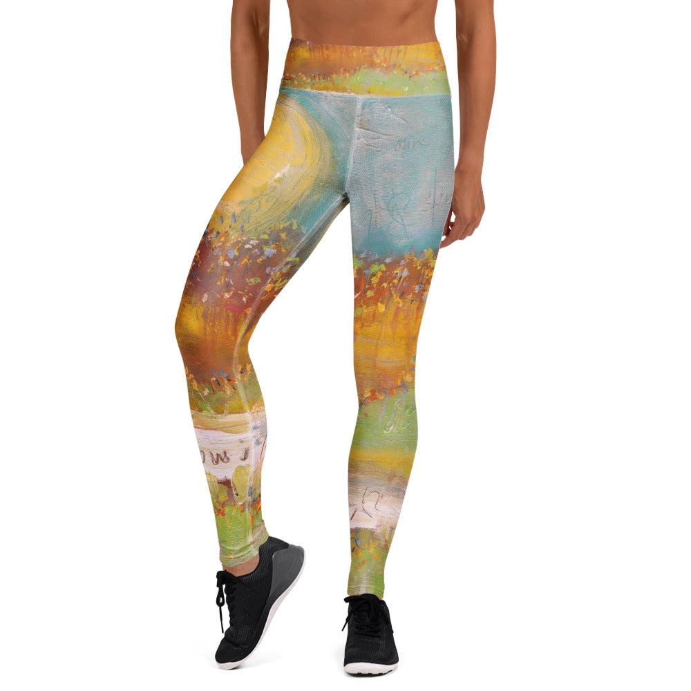 Front of the leggings with black sneakers, yellow sun on one thigh and teal paint on the other