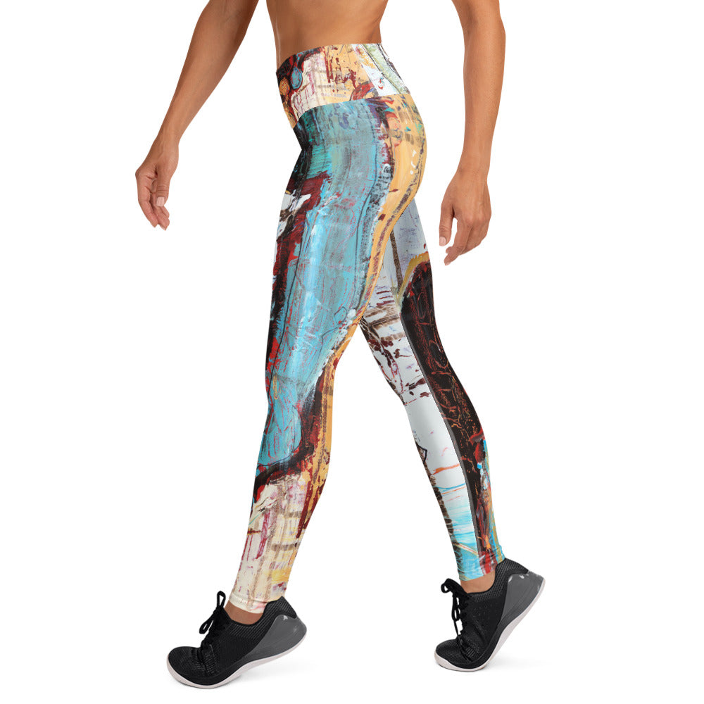 Side view of model walking in the leggings, a teal band down the leg beside ochre and black
