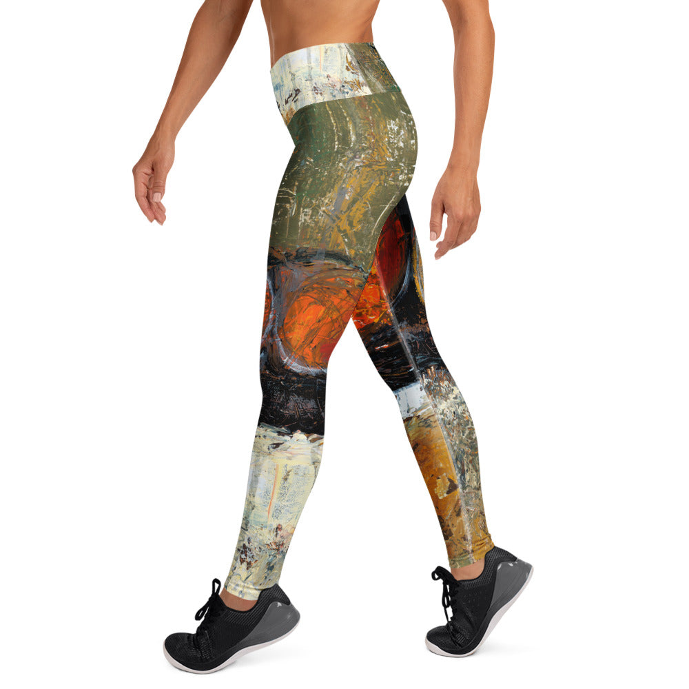 Right side view of the leggings mid-stride, orange circles over olive and black bands