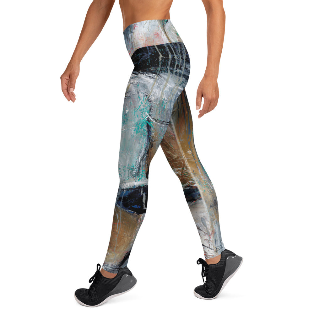 Right side view of the leggings mid-stride, black band at the hip over white and teal strokes