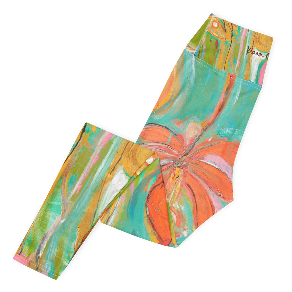 Folded leggings flat lay with a large orange flower and turquoise waistband