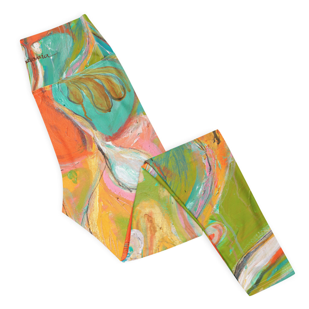 Folded leggings flat lay showing the back waistband signature and orange and green paint