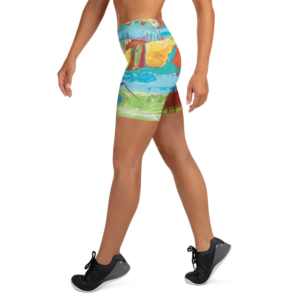 Right side view of the yoga shorts mid-stride, yellow and turquoise bands over green