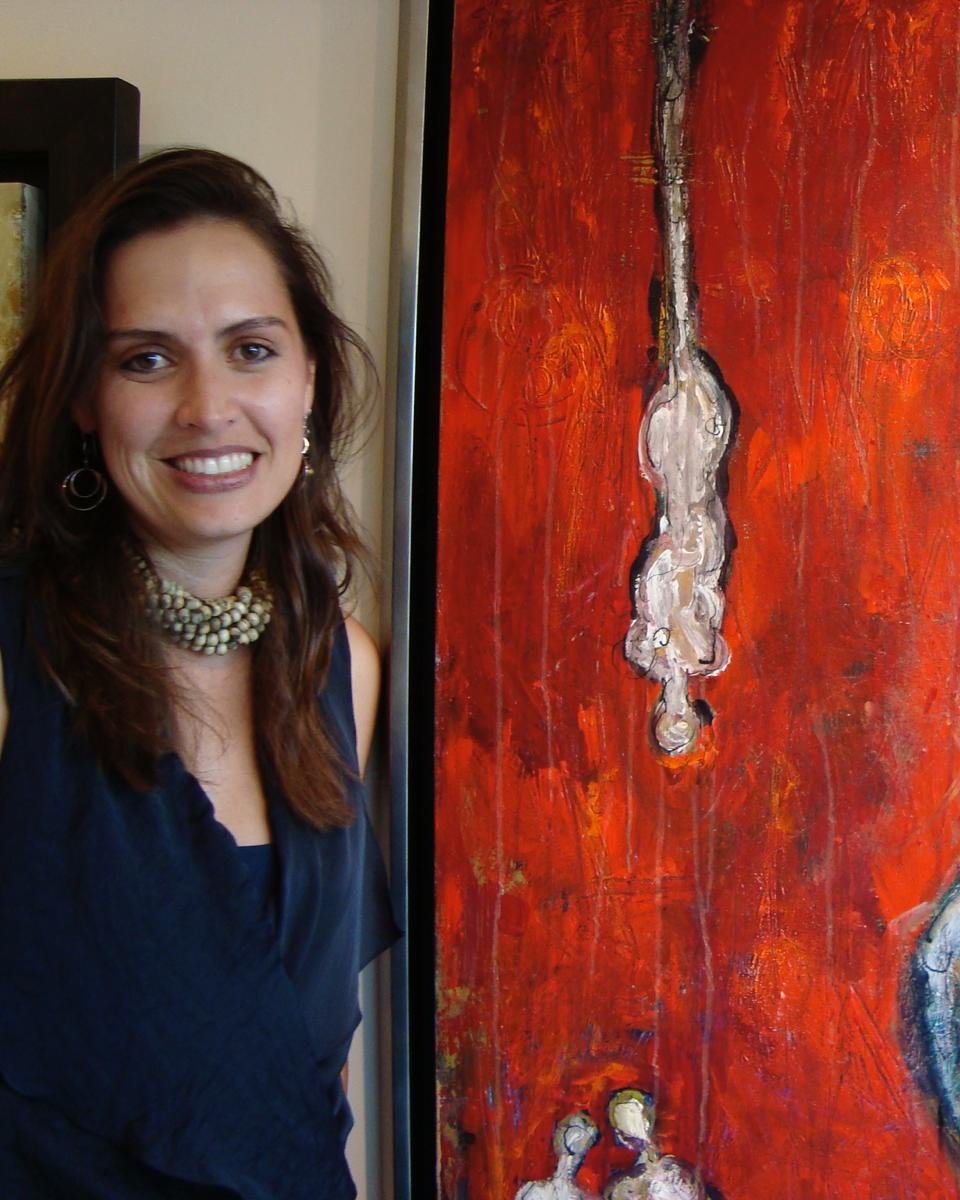 Klara Chavarría, artist, beside her red painting