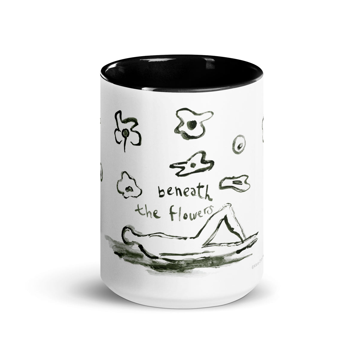 Front of the mug showing the handwritten words beneath the flowers above a figure lying down among ink flowers