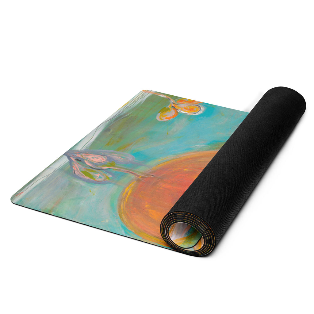 Mat unrolling from a black roll, revealing an orange sun and lilac blossom on turquoise